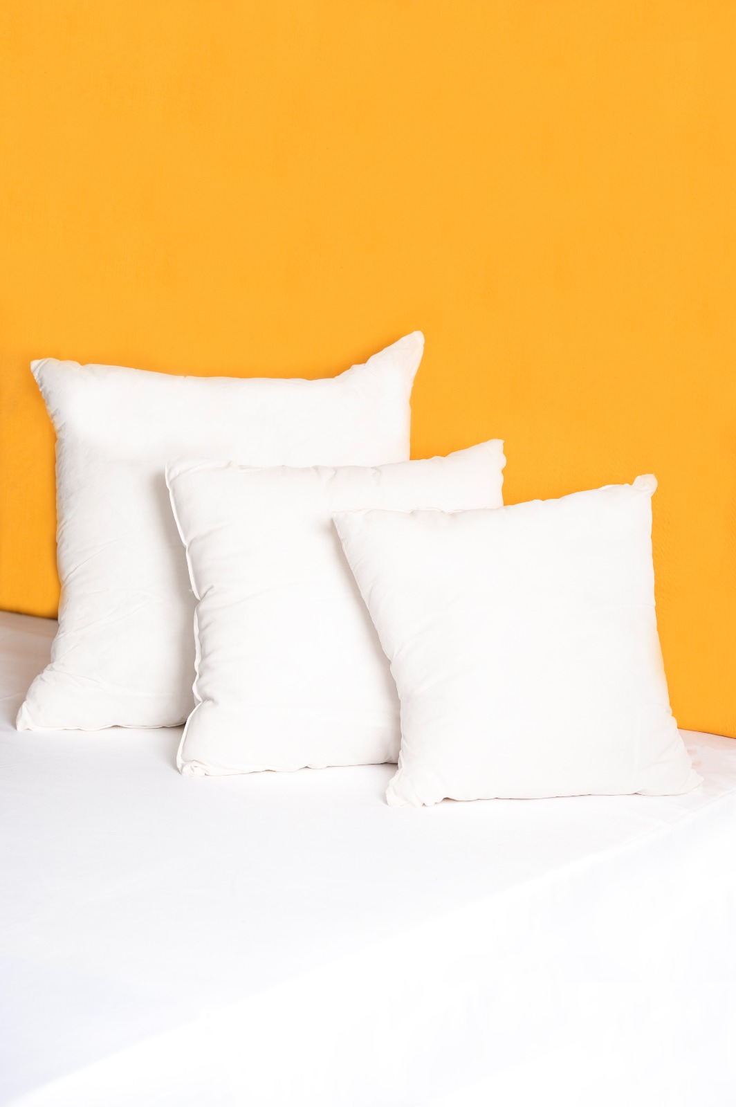 Set of white cushion inserts in three sizes